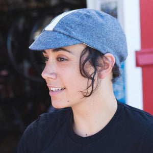 Side profile of woman wearing gray wool 3-panel stripe cap.