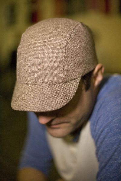 Man wearing Velo/City Cap - Brown Tweed Wool. Looking down.