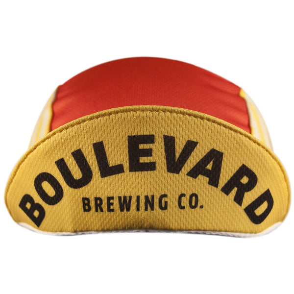 Boulevard Brewing Co. 3-Panel Technical Cycling Cap. Red and yellow cap with Boulevard Brewing Co. text under brim.  Brim up front view.