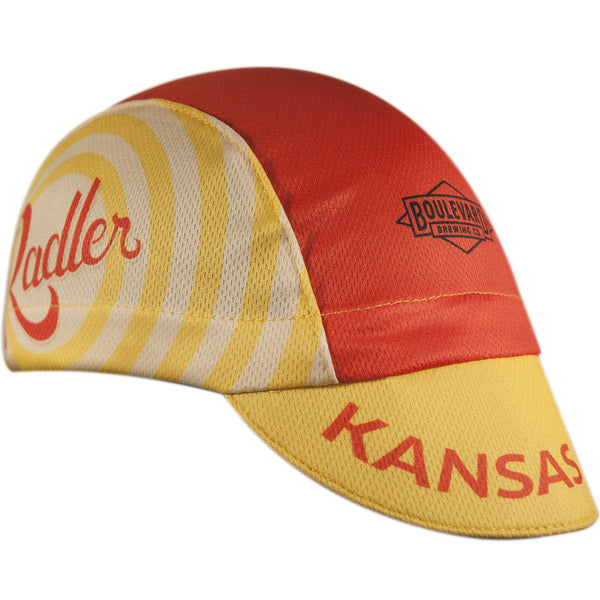 Boulevard Brewing Co. 3-Panel Technical Cycling Cap. Red and yellow cap with Boulevard logo, Radler text on side, Kansas text on brim.  Angled view.