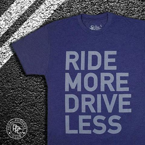 Blue t-shirt with gray text: "RIDE MORE DRIVE LESS"