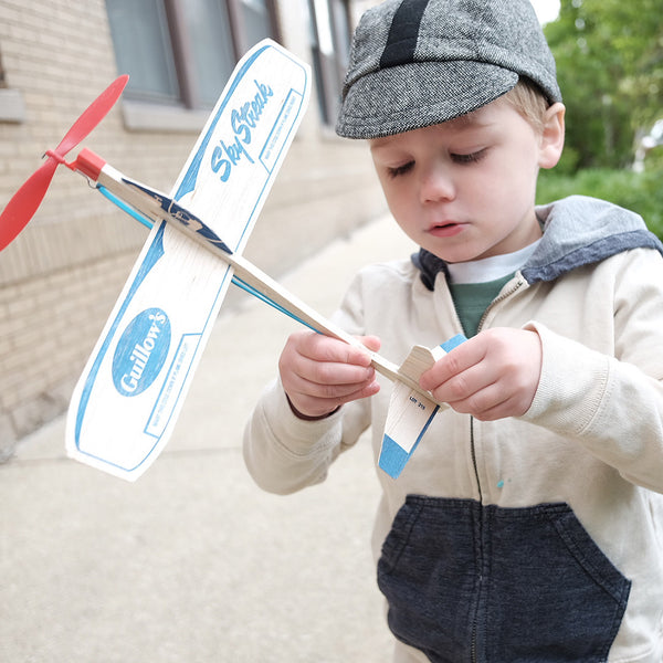 Child wearing the Buckaroo kids cap and playing with a toy airplane.