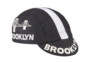 Brooklyn Black Cotton 3-Panel Cycling Cap.  White stripe with Brooklyn bridge logo and Brooklyn text on side and brim.  Angled view.