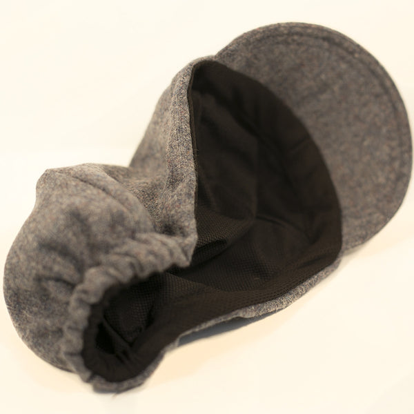 Underside view of a gray cap showing the black lining.