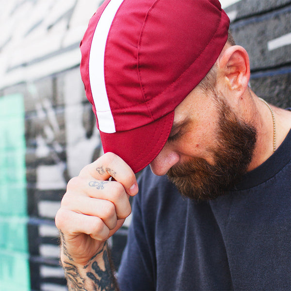 Man wearing dodge fast cap holding brim.