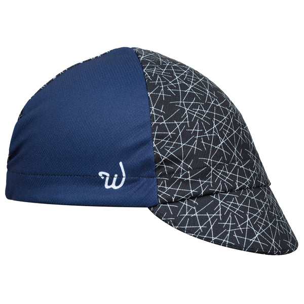 "Dart" Technical 4-Panel Cap.  Navy blue cap with black and white cross-stitch print.  Angled View.