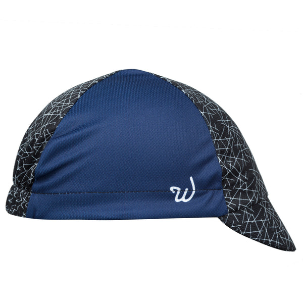 "Dart" Technical 4-Panel Cap.  Navy blue cap with black and white cross-stitch print.  Side View.