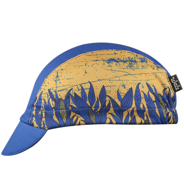 Nebraska Technical 3-Panel Cycling Cap. Blue and yellow cap with corn print on side.  Side view.