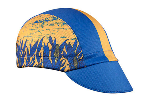 Nebraska Technical 3-Panel Cycling Cap. Blue and yellow cap with corn print on side.  Angled view.