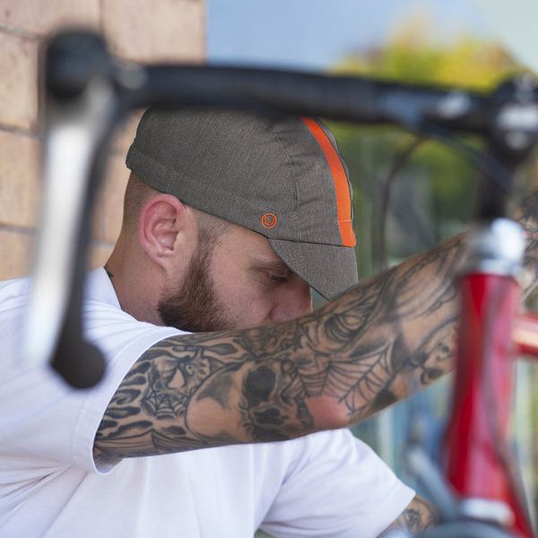 Man working on a bike wearing the collegiate fast cap.
