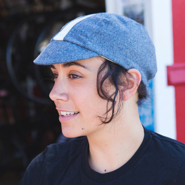 Woman wearing blue cadet wool cap.