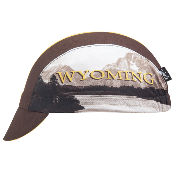 Wyoming Technical 3-Panel Cycling Cap. Brown cap with yellow stripe and Grand Teton imagery on side.  Side view.