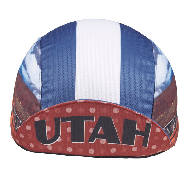 Utah Technical 3-Panel Cycling Cap. Blue and white cap with Delicate Arch image on side. UTAH text under brim. Brim up front view.