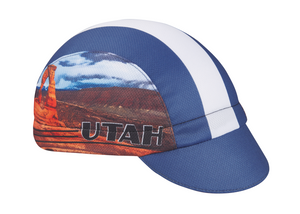 Utah Technical 3-Panel Cycling Cap. Blue and white cap with Delicate Arch image on side. Angled view.