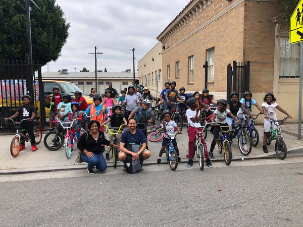 Group of kids outside on bikes.