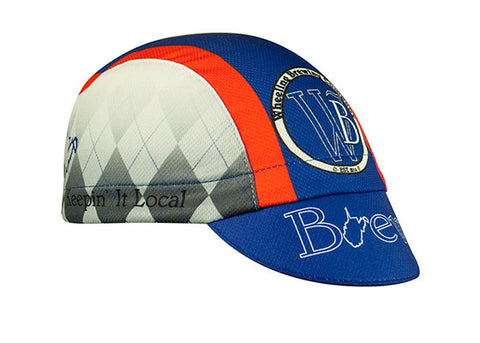 Wheeling Brewing Co. Technical 3-Panel Cycling Cap. Blue and orange cap with gray argyle pattern on side.  Wheeling brewing company imagery on side, front, and brim.  Angled view.
