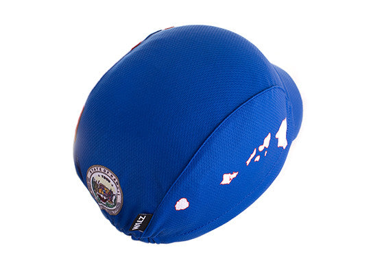 Hawaii Technical 3-Panel Cycling Cap.  Blue cap with white Hawaii state outline on side and Hawaii state seal on the back. Overhead back view.