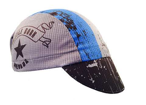 Nevada 3-Panel Technical Cycling Cap.  Gray, blue, and black cap with Nevada Battle Born text on side.  Angled view.